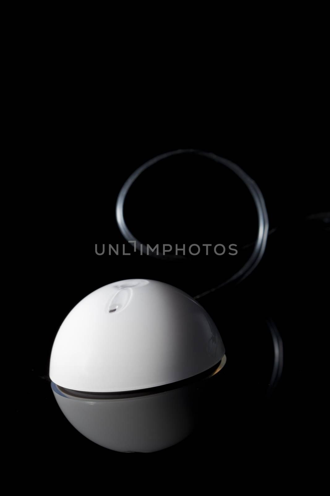 White portable GPS receiver isolated on black background.