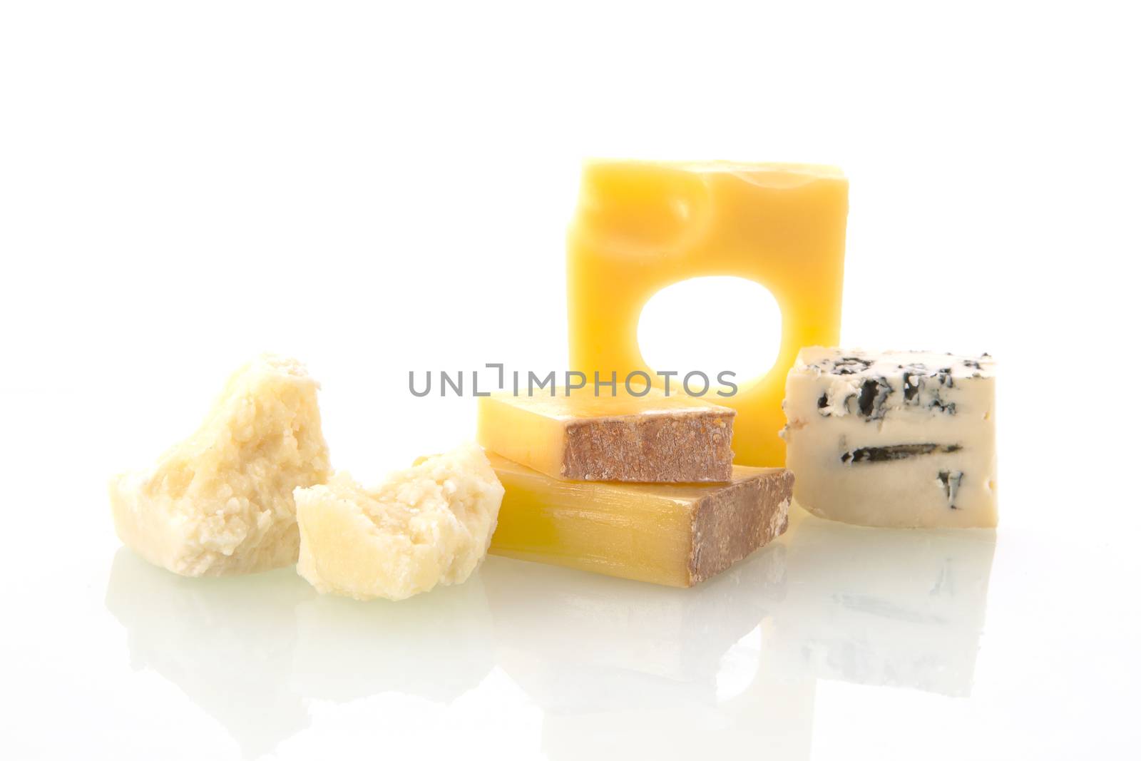 Various cheese types isolated on white background. Emmentaler, pargmiano and blue cheese and other. 