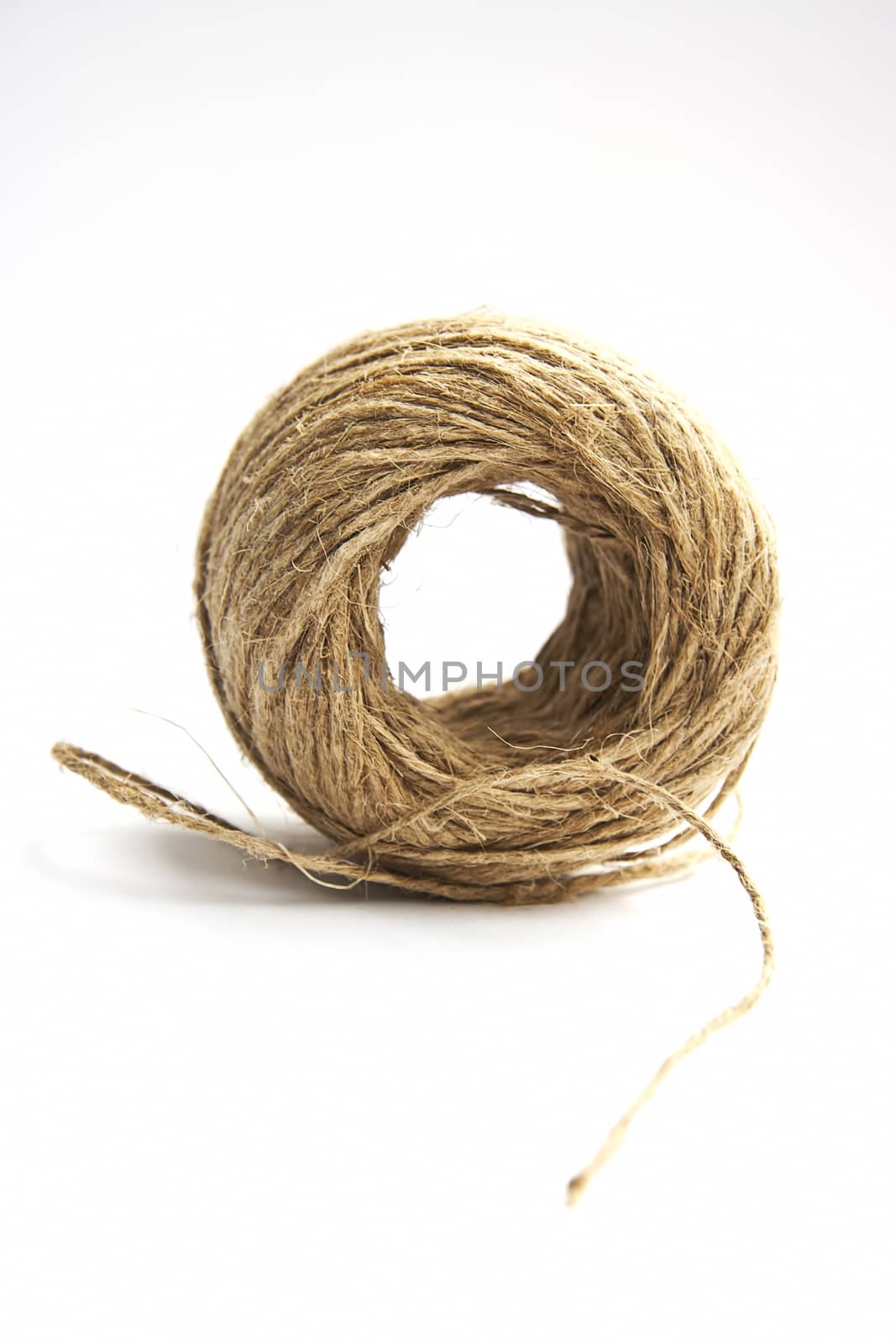 brown cord ball on white background by eskymaks