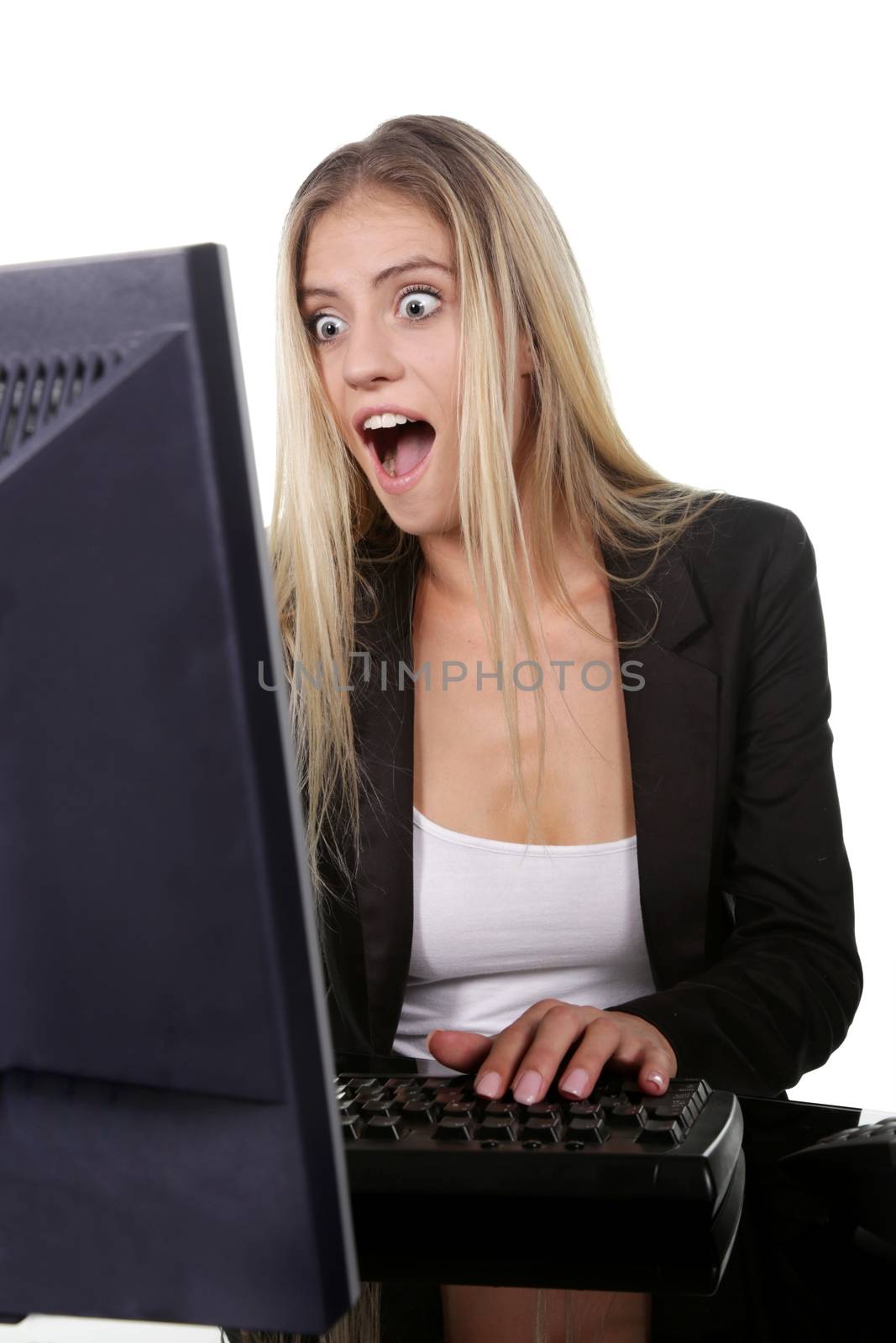 Pretty blond office secretary lady with shocked expression looking at her screen
