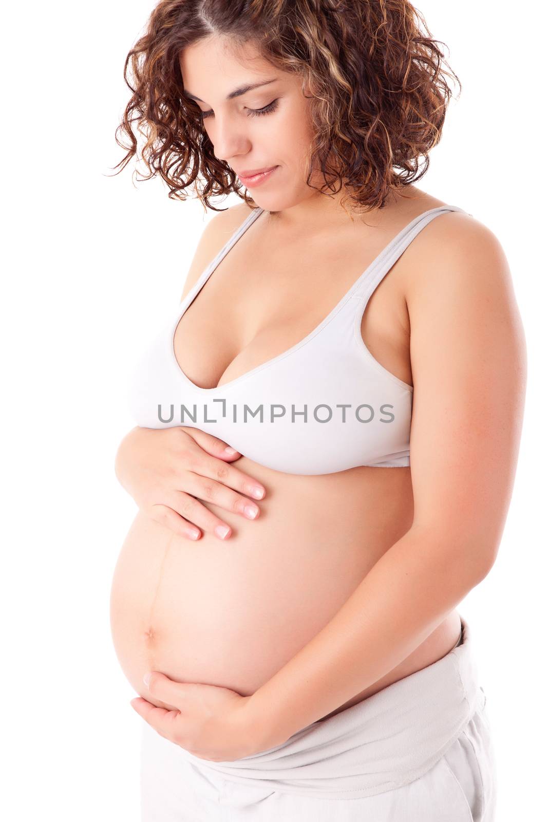 Beautiful pregnant woman showing her good shape over white background