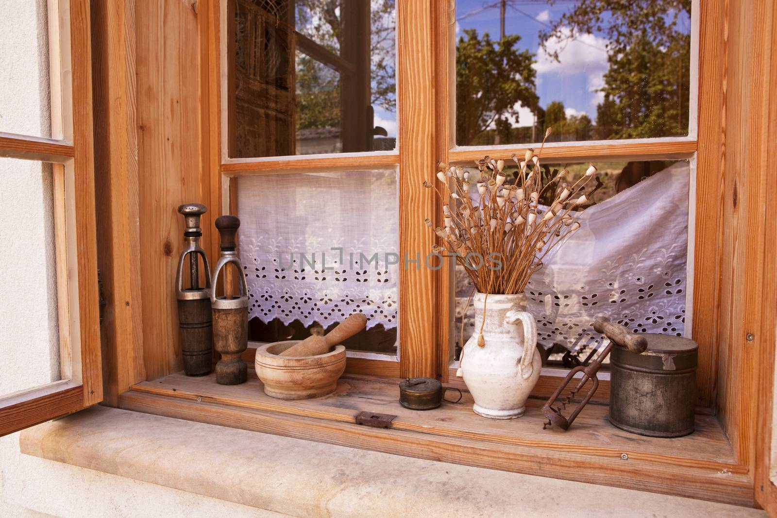 Traditional window in countryside with old vintage objects. Traditional farming still life.