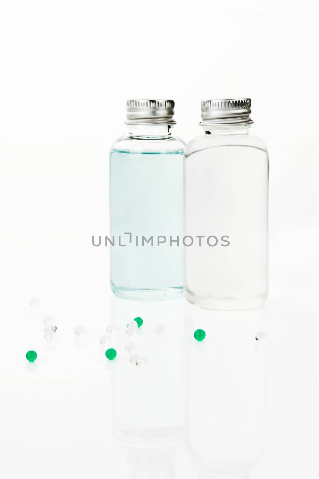 Shampoo and shower gel in transparent bottles isolated on white background. 