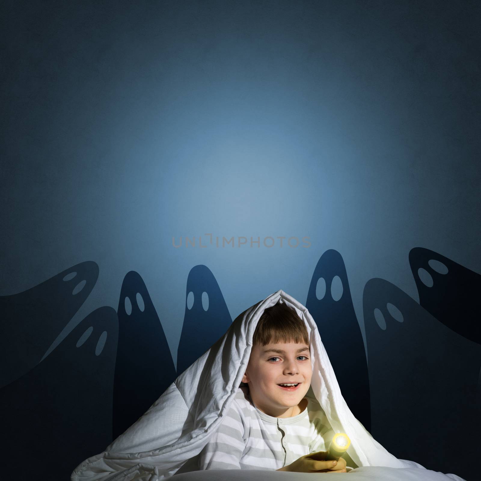 image of a boy under the covers with a flashlight