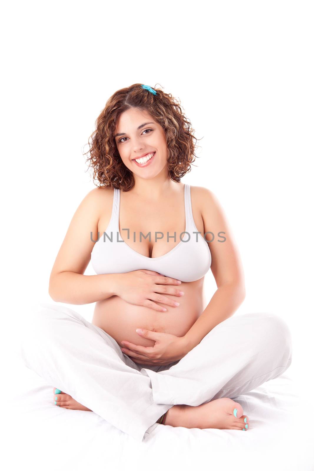 Beautiful pregnant woman showing her good shape over white background