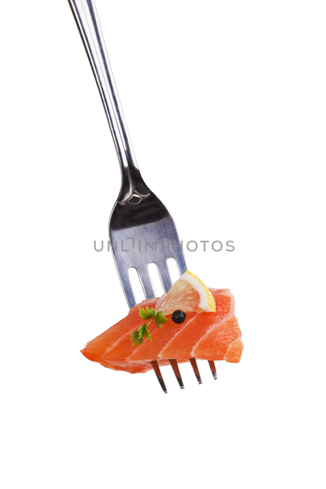 Salmon piece with lemon, pepper corn and herb arranged on fork.
