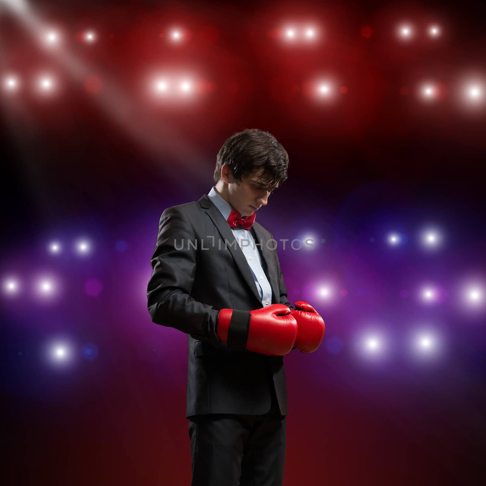 image of a businessman with boxing gloves in the ring, the competition in the business