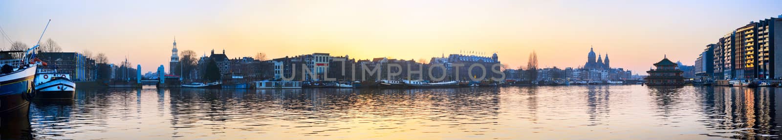 Panorama of Amsterdam old town with reflection in Amstel river