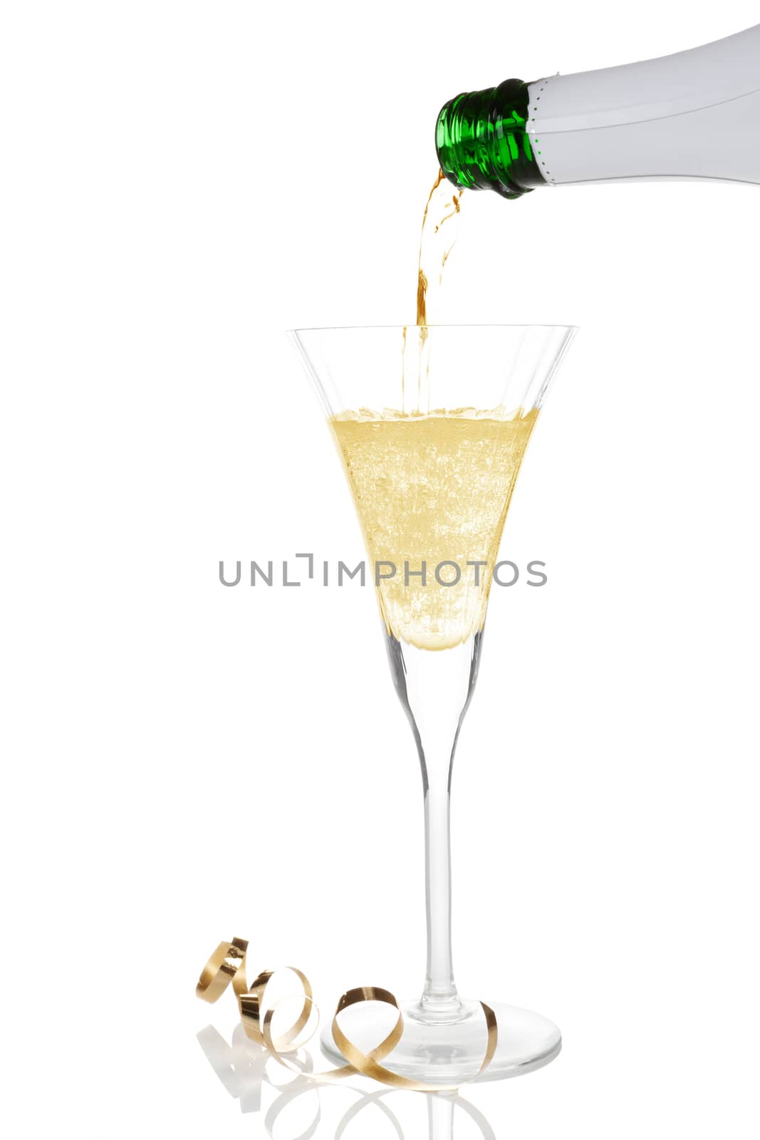 Pouring golden champagne into a glass isolated on white. Luxury celebration concept.