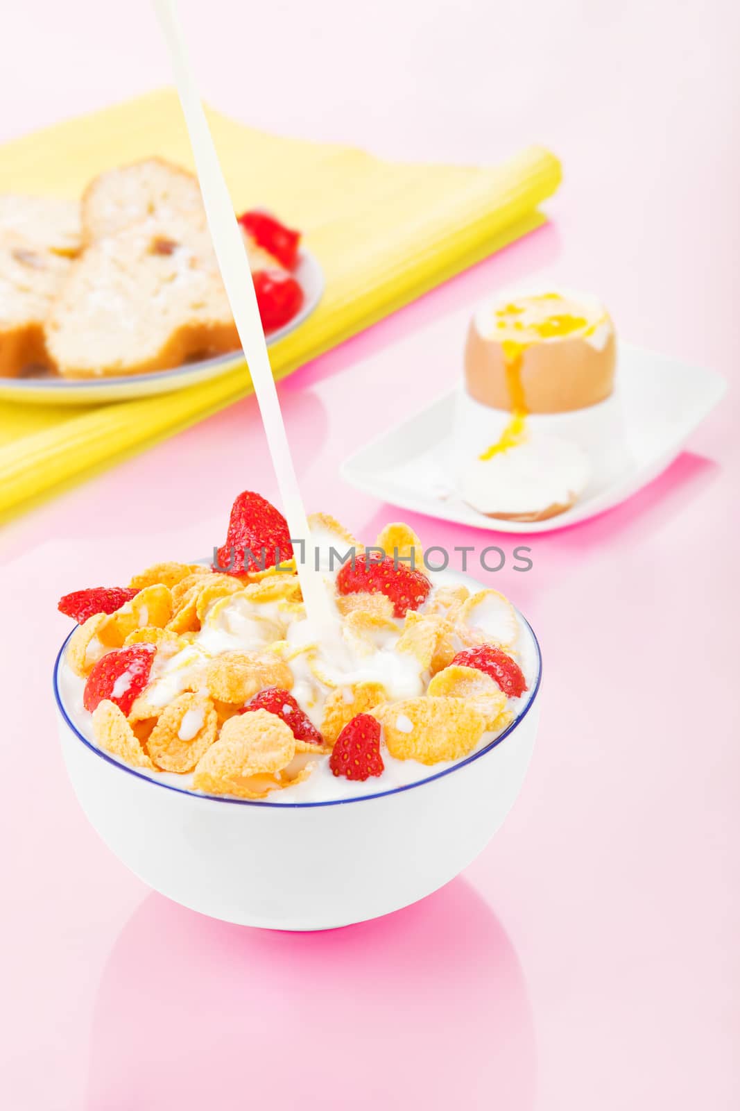 Delicious breakfast in pink and yellow. Cereal, egg and pastry. by eskymaks