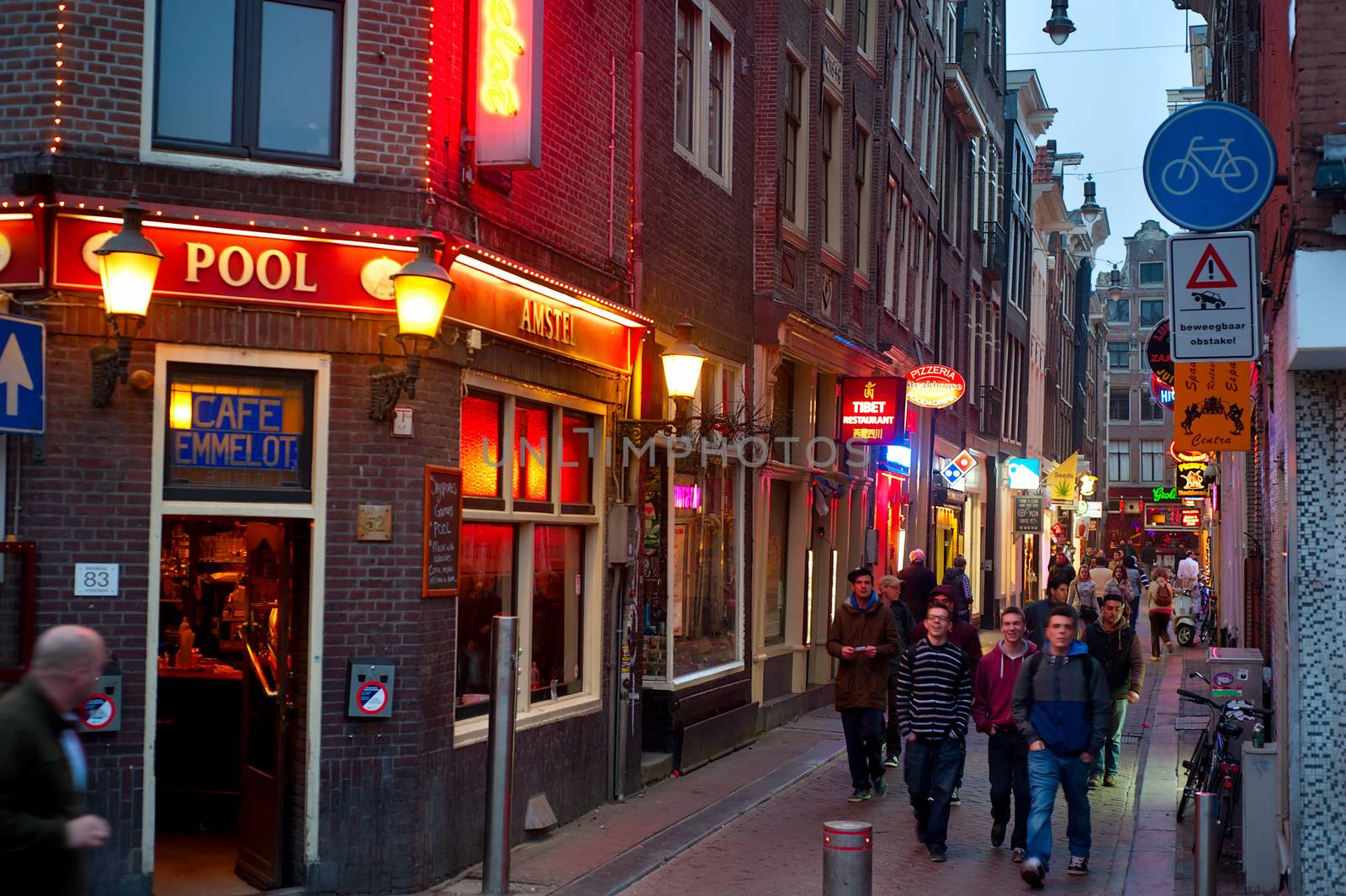AMSTERDAM, NETHERLANDS - MARCH 10, 2014: People at Old Town street in Amsterdam. Amsterdam is the capital city of and the most populous within the Kingdom of the Netherlands