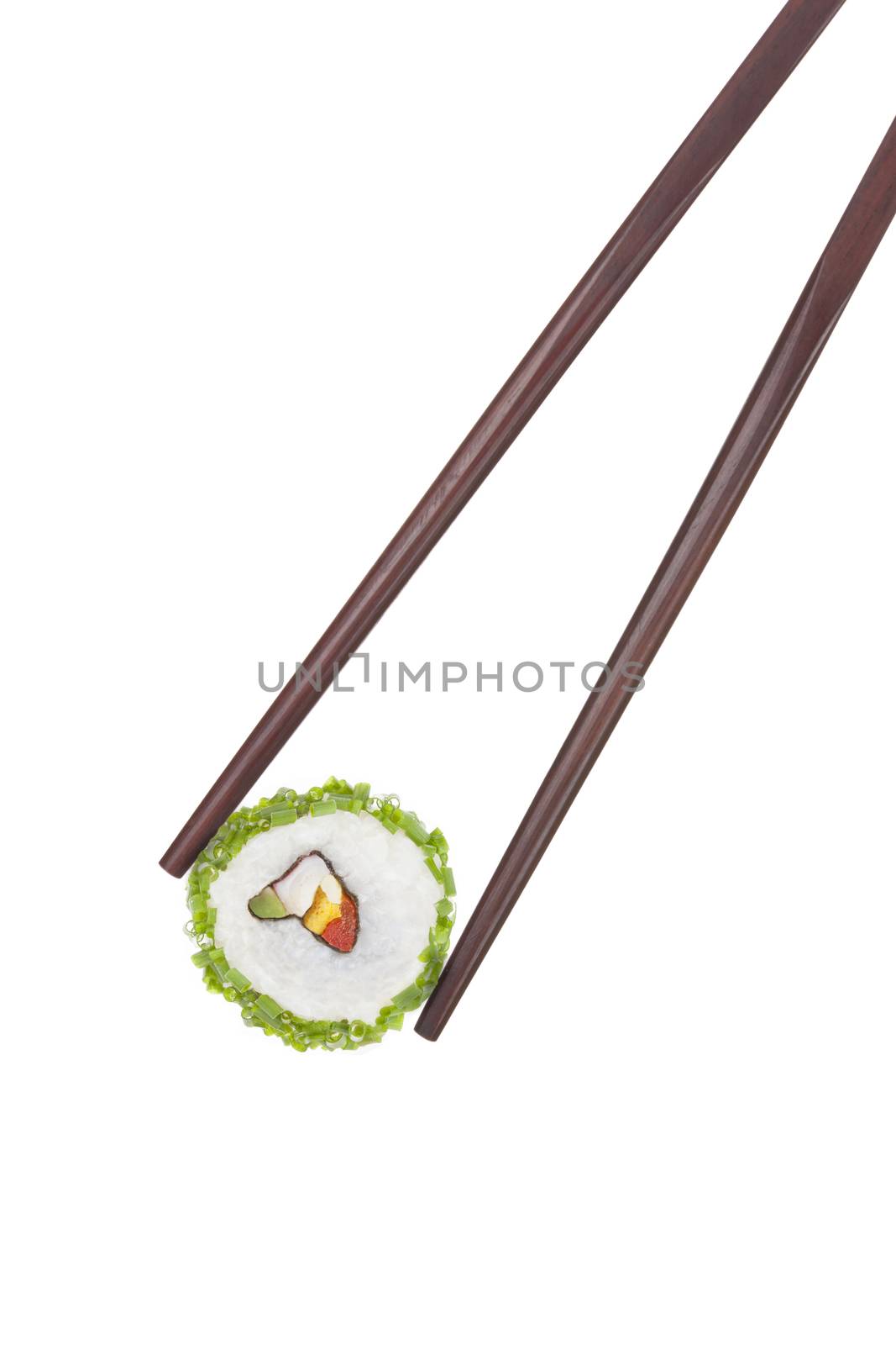 Holding a california maki sushi piece with chopped chive in chopsticks isolated on white background. Culinary gourmet japanese food. 