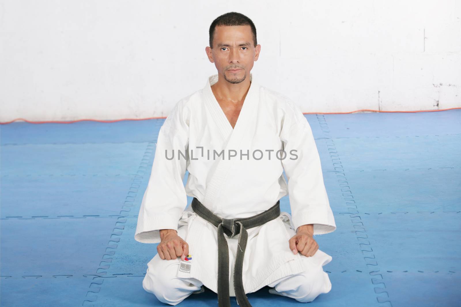 Black Belt karate man sit on a position to start or finish pract by dacasdo