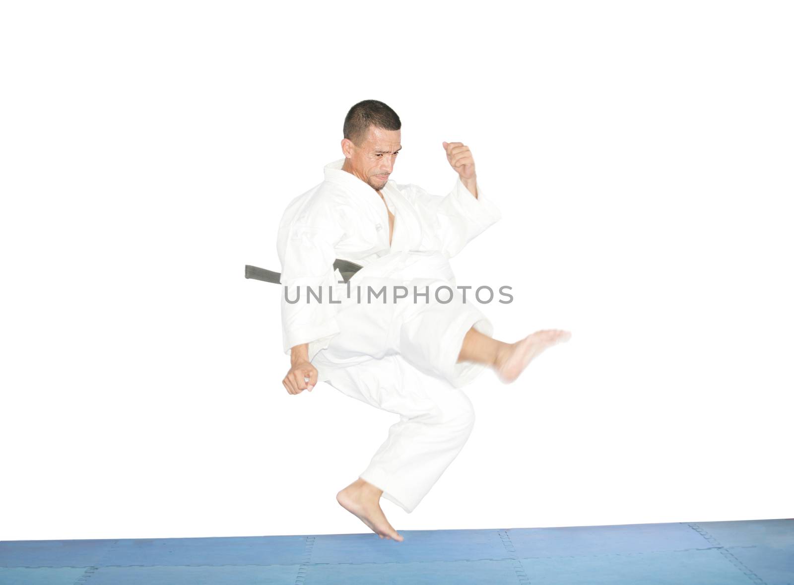 american man in karate suit, suspended in mid air by dacasdo
