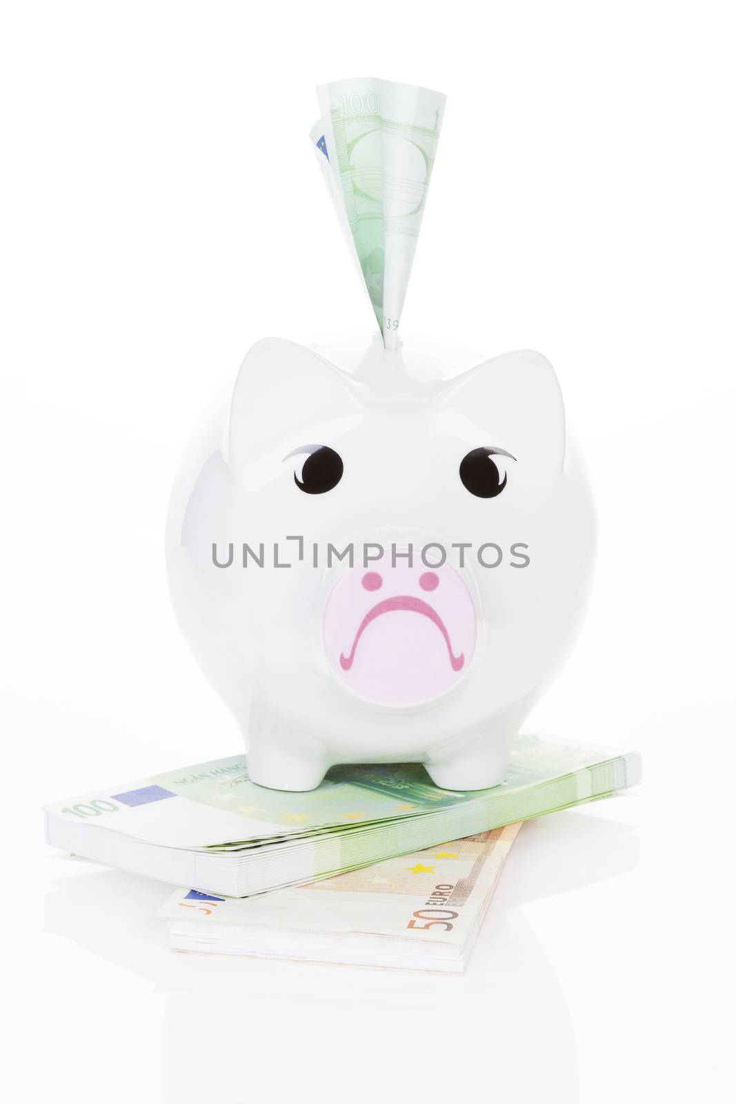 Sad piggy bank with money. Money does not make you happy. by eskymaks