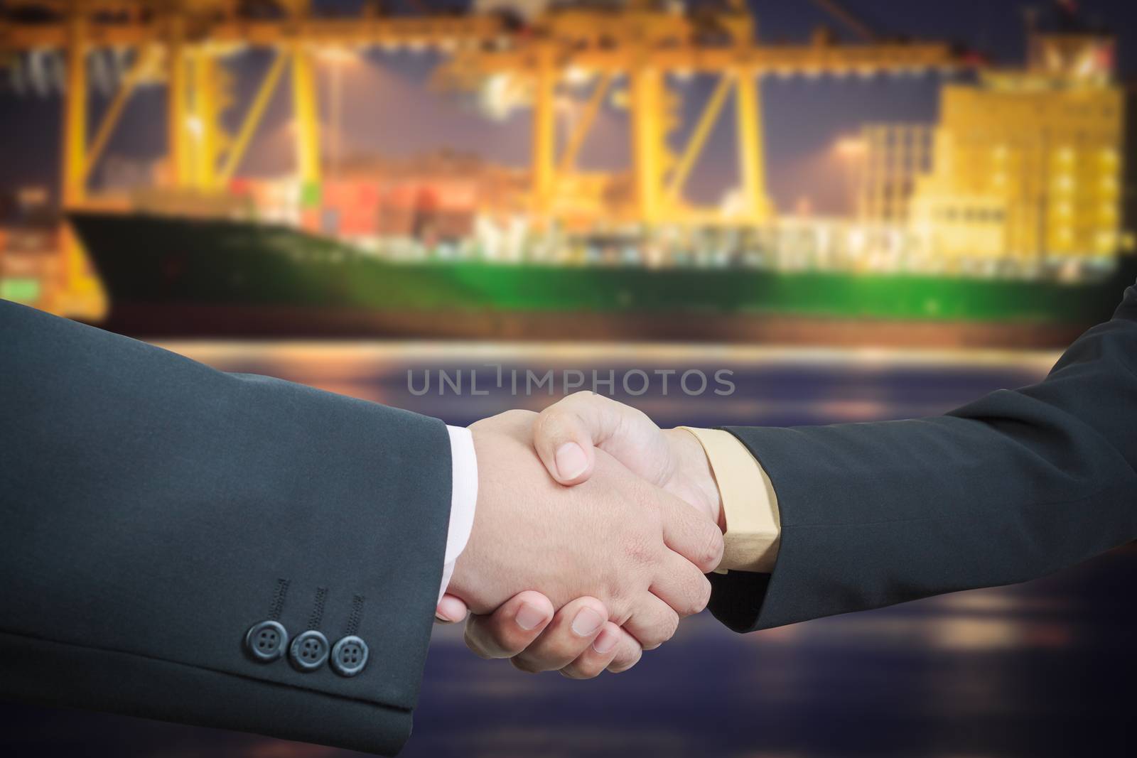 Businessman handshake with ship transportation logistic background