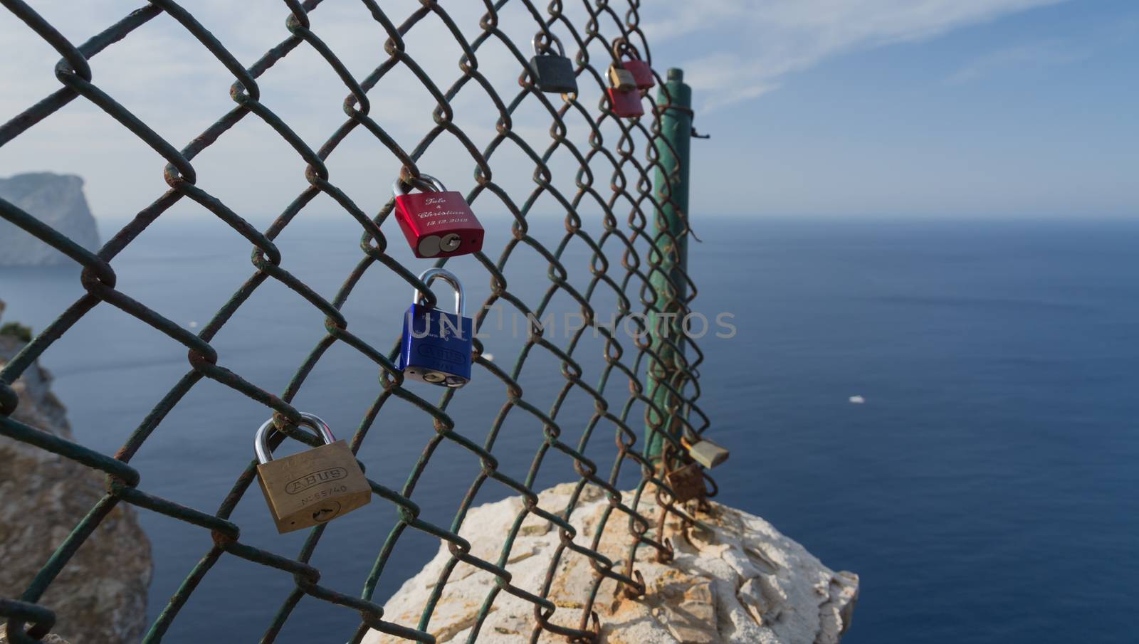 Padlocks on Formentor - couple in love have placed inscripted padlocks on the fence by the lighthouse as a symbol for their eternal love.