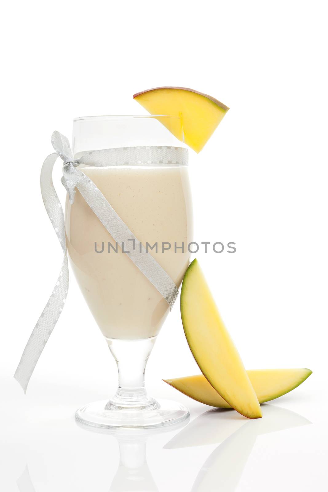 Delicious mango fruit smoothie with fresh mango fruit isolated on white background. Culinary tropical cocktail drinks.
