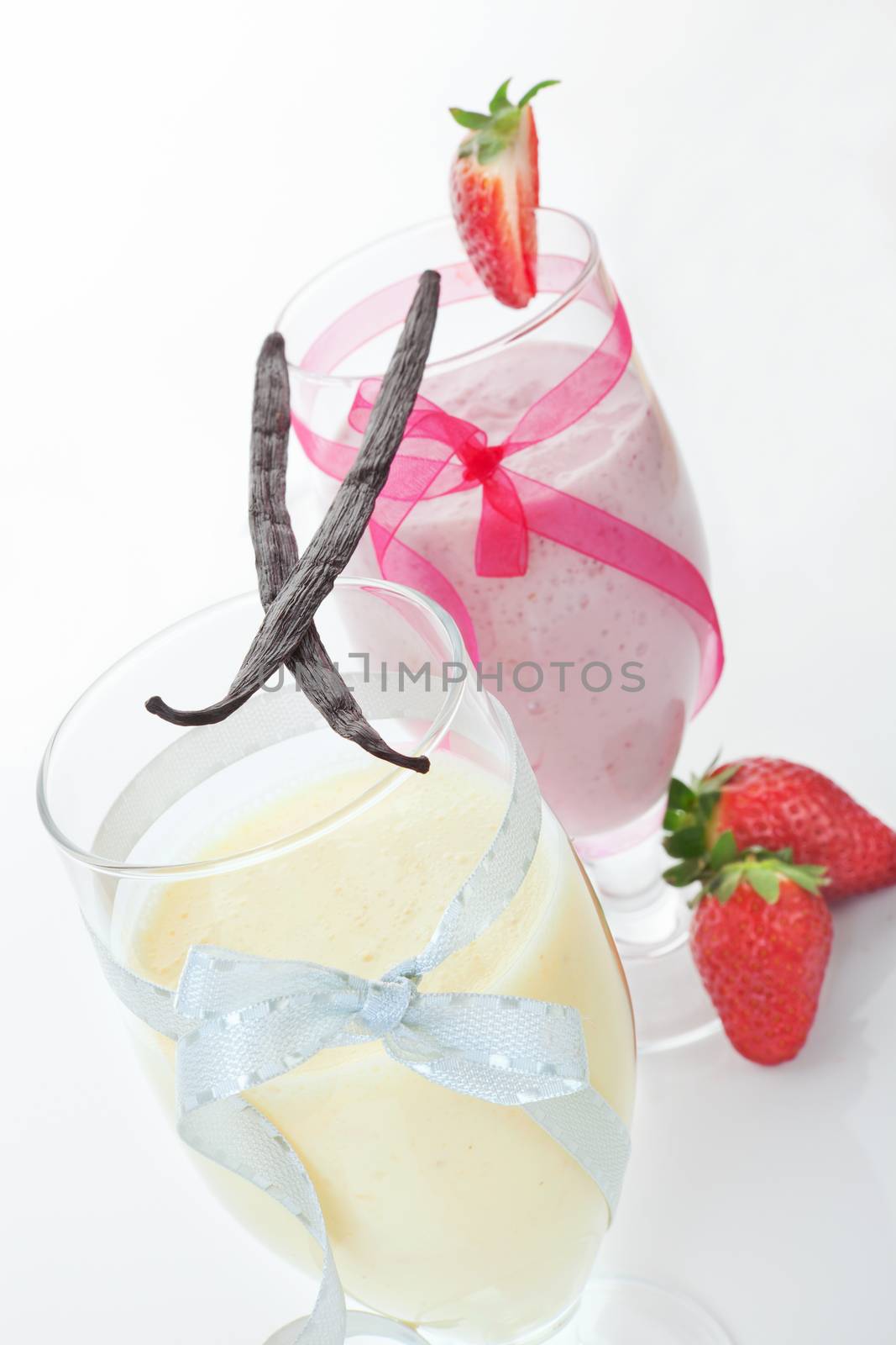 Culinary summer fruit cocktails. Vanilla smoothie and strawberry smoothie garnished with fresh fruit. Enjoy summer. 