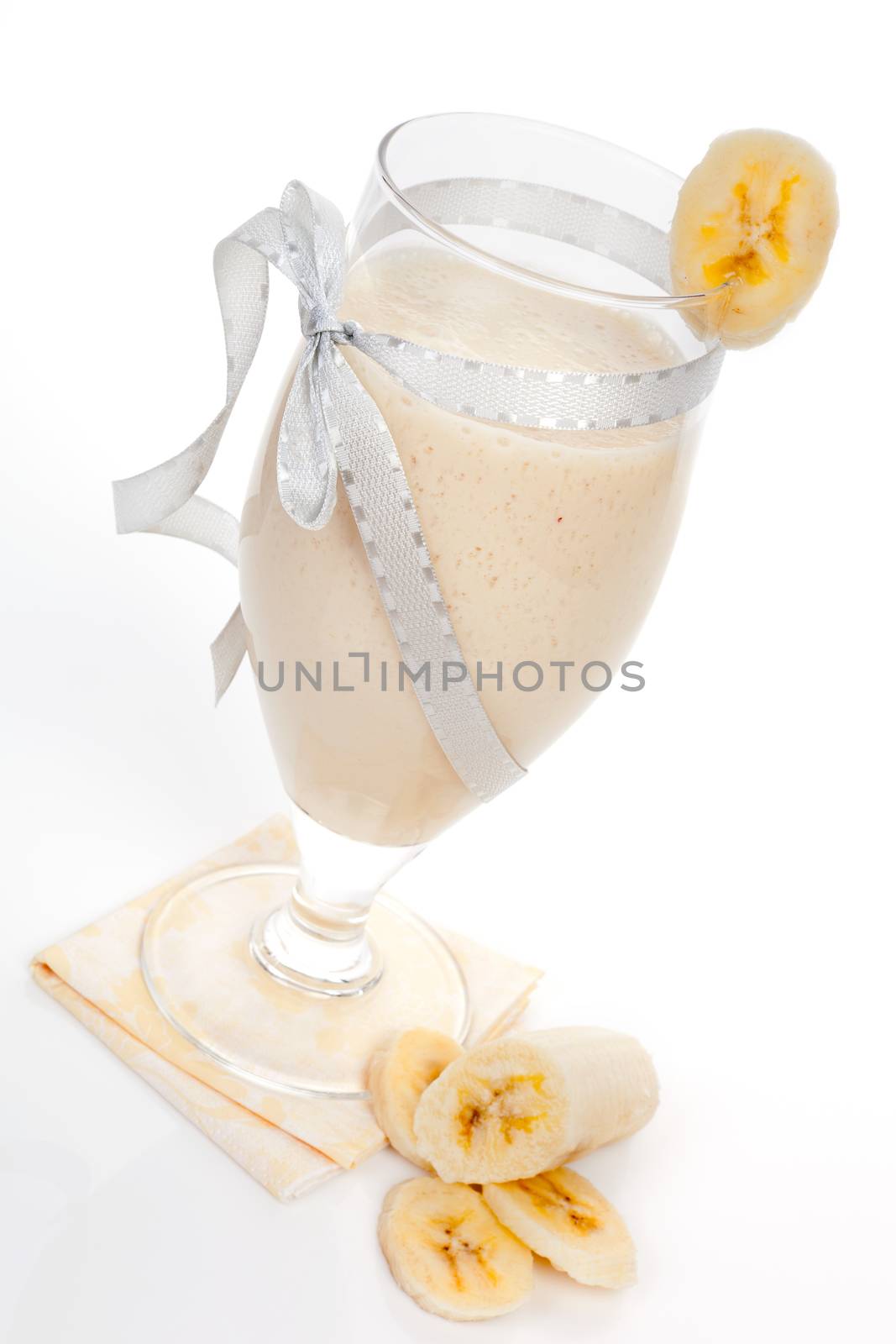 Delicious banana milkshake with fresh banana isolated on white background. Healthy summer beverages.