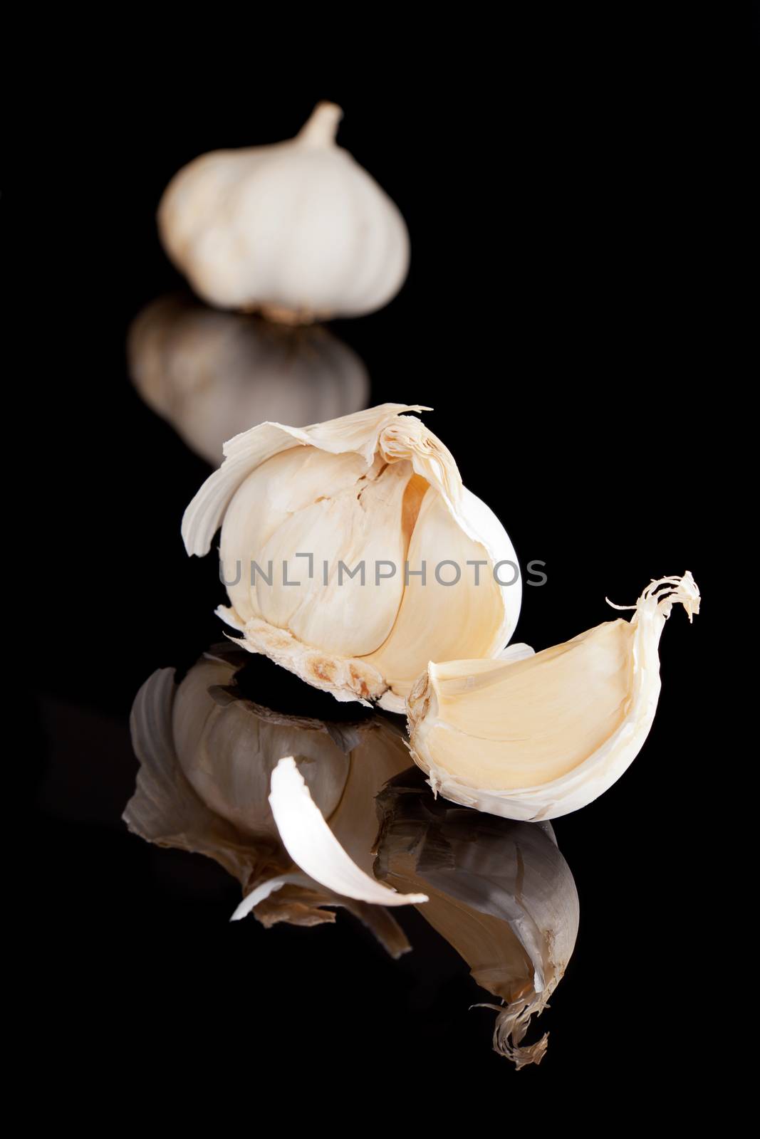 Garlic isolated on black background. Culinary cooking ingredient.