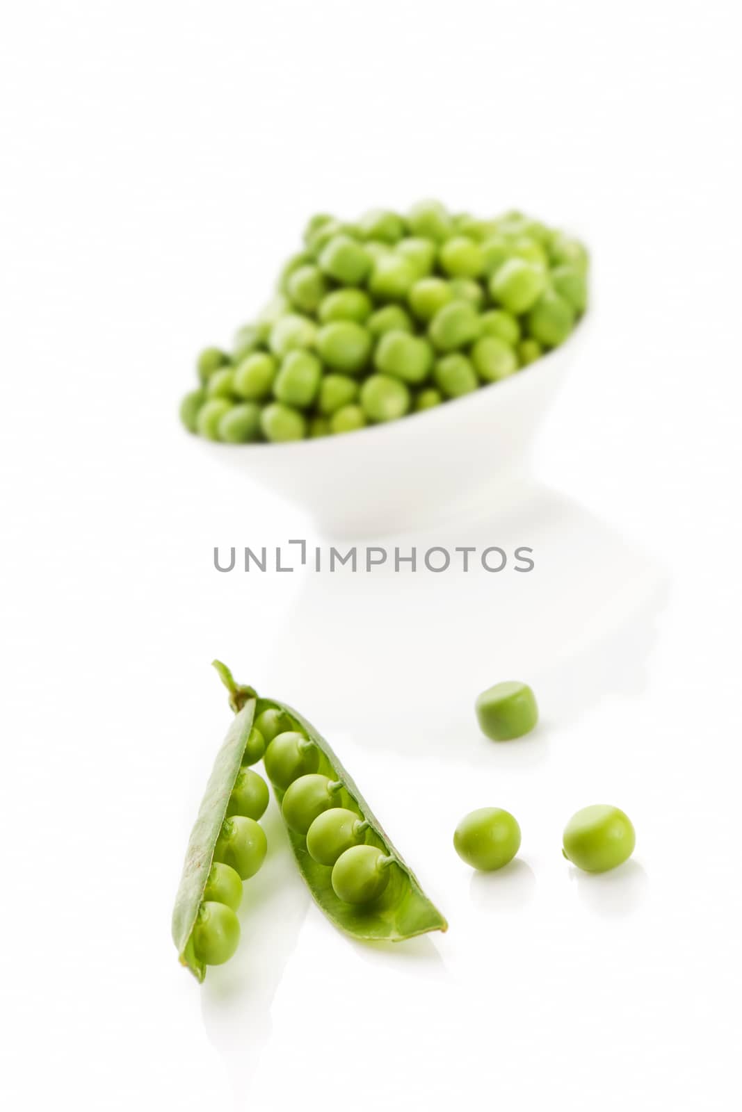 Pea pod and peas in bowl isolated on white background. Culinary summer legume vegetable. 