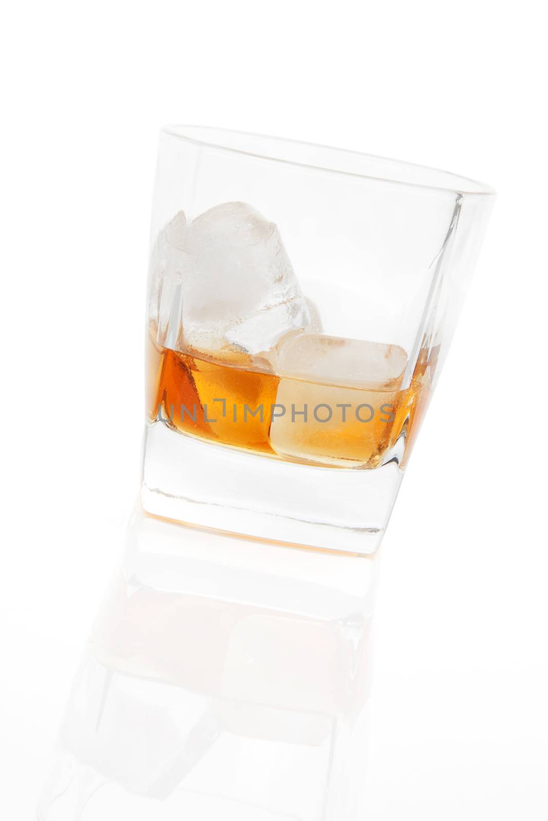 Whiskey with ice in glass isolated on white background. Luxurious leisure concept.