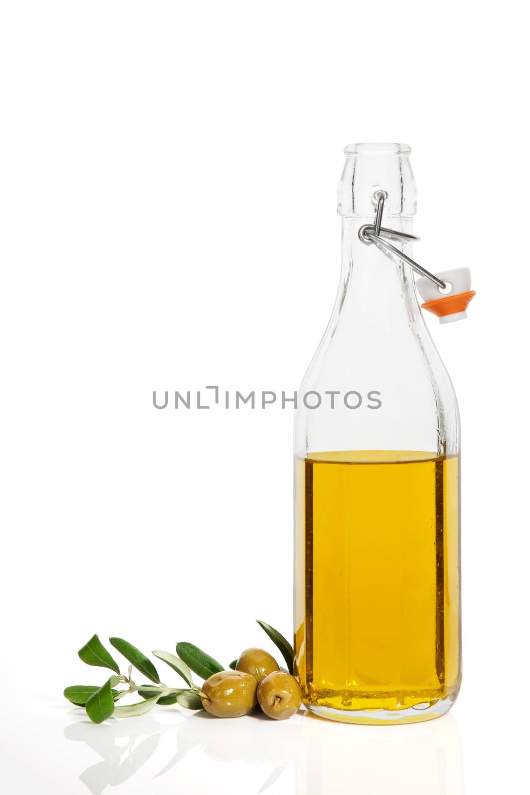 Luxurious olive oil background with fresh olives, branch and bottle with extra virgin oil isolated on white background. Culinary cooking concept.