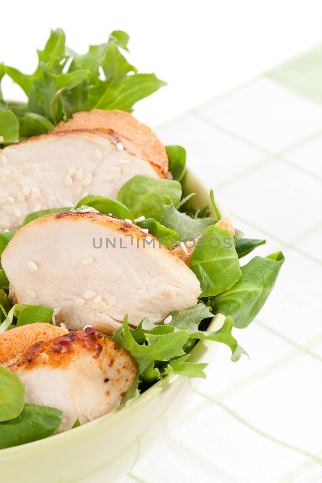 Delicious salad with chicken pieces in green bowl. Luxurious light summer eating. 