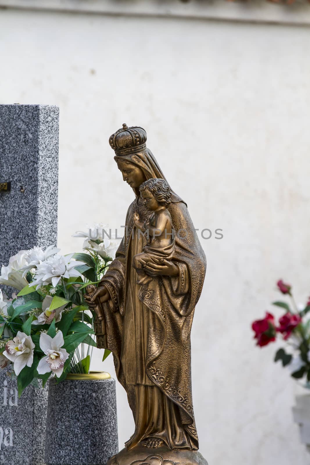 sculpture of the Virgin Mary in a cemetery by FernandoCortes