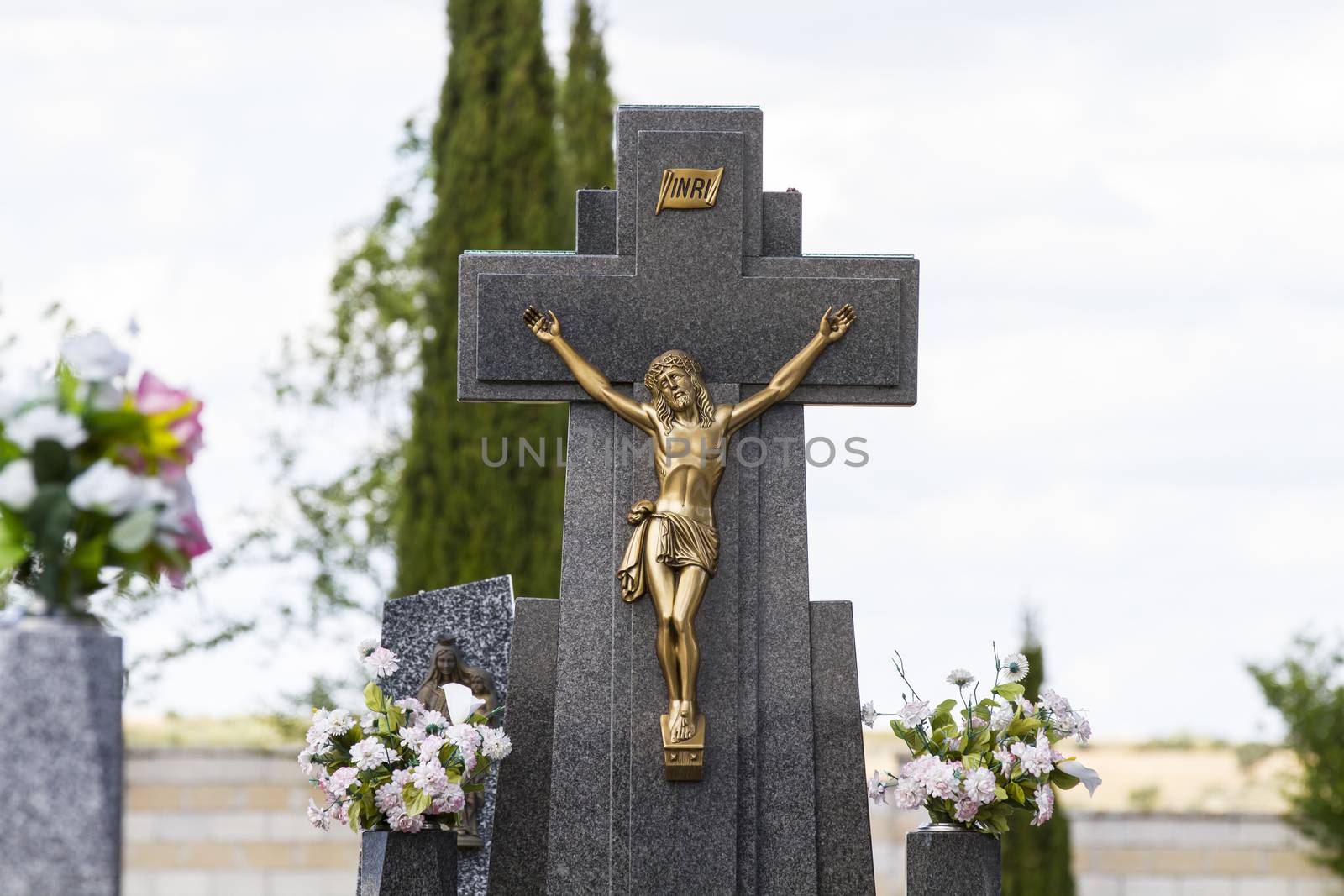 Jesus Christ on the cross in a cemetery by FernandoCortes