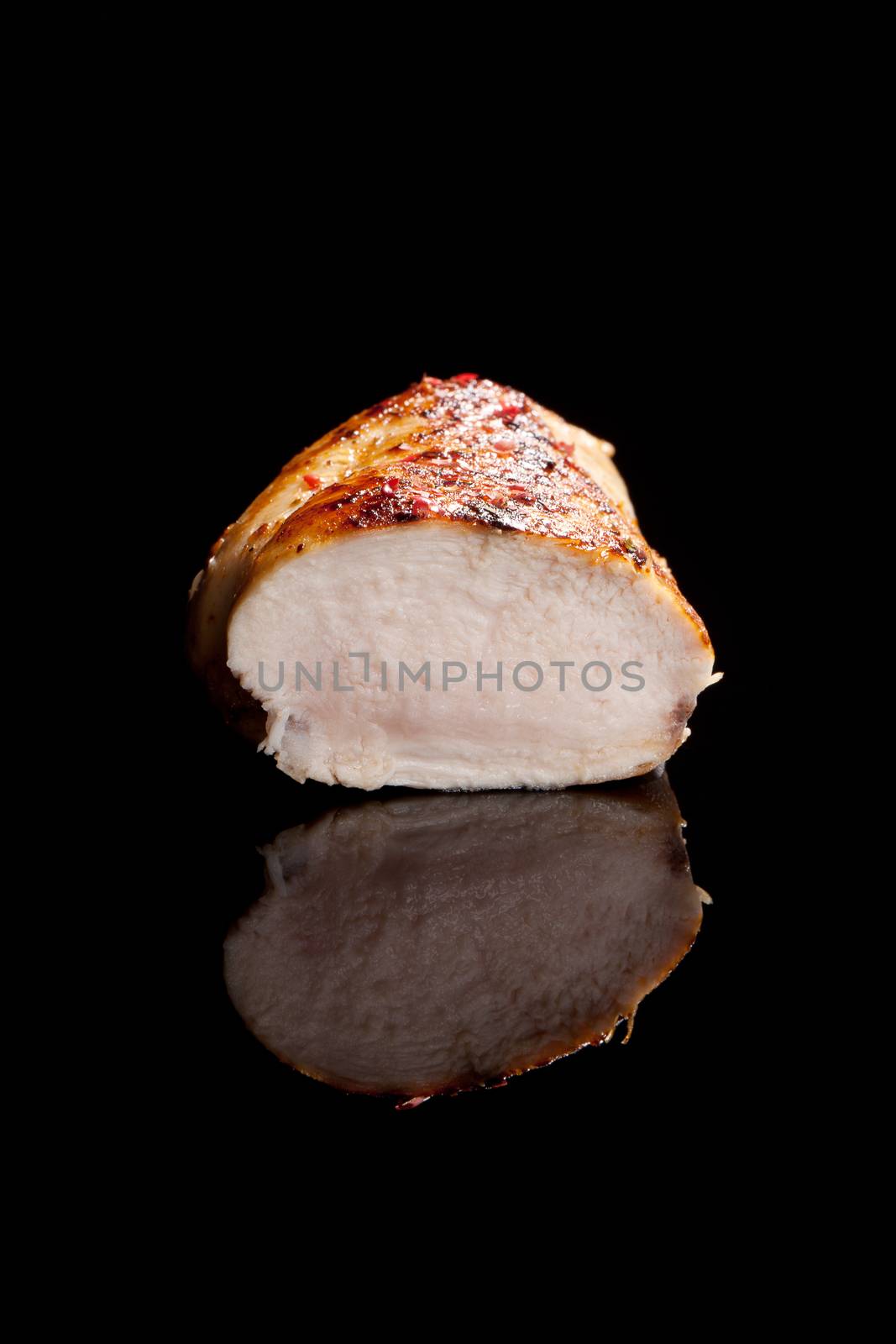 Luxurious juicy poultry steak isolated on black background. Culinary eating.