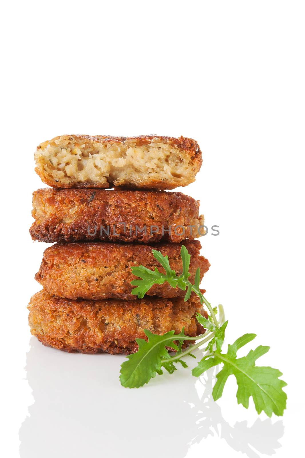 Delicious veggie burger patty tower with fresh arugula herb isolated on white background. Culinary vegetarian food.