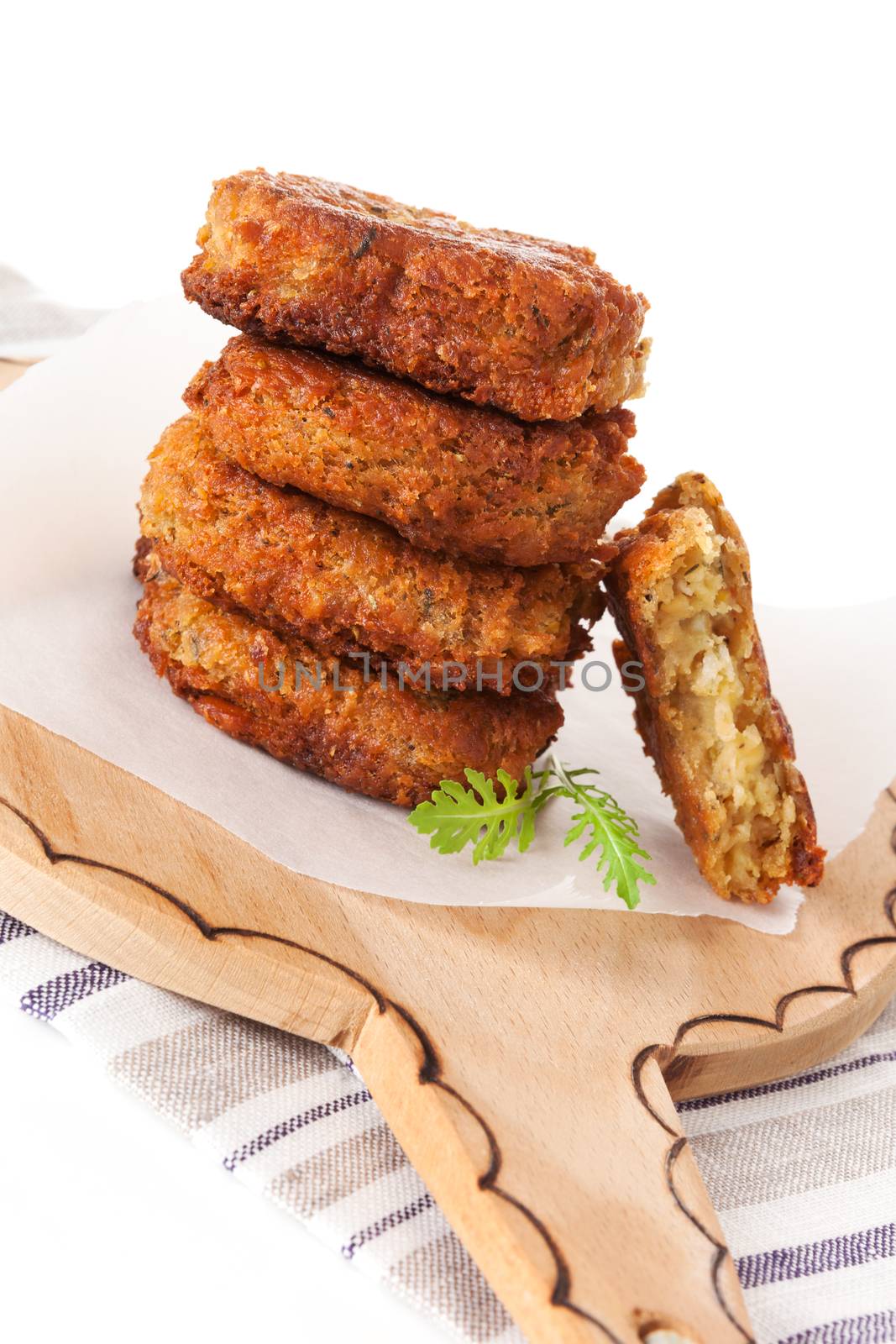 Delicious falafel background. Falafel patty pile on round wooden chopping board. Vegetarian eating.