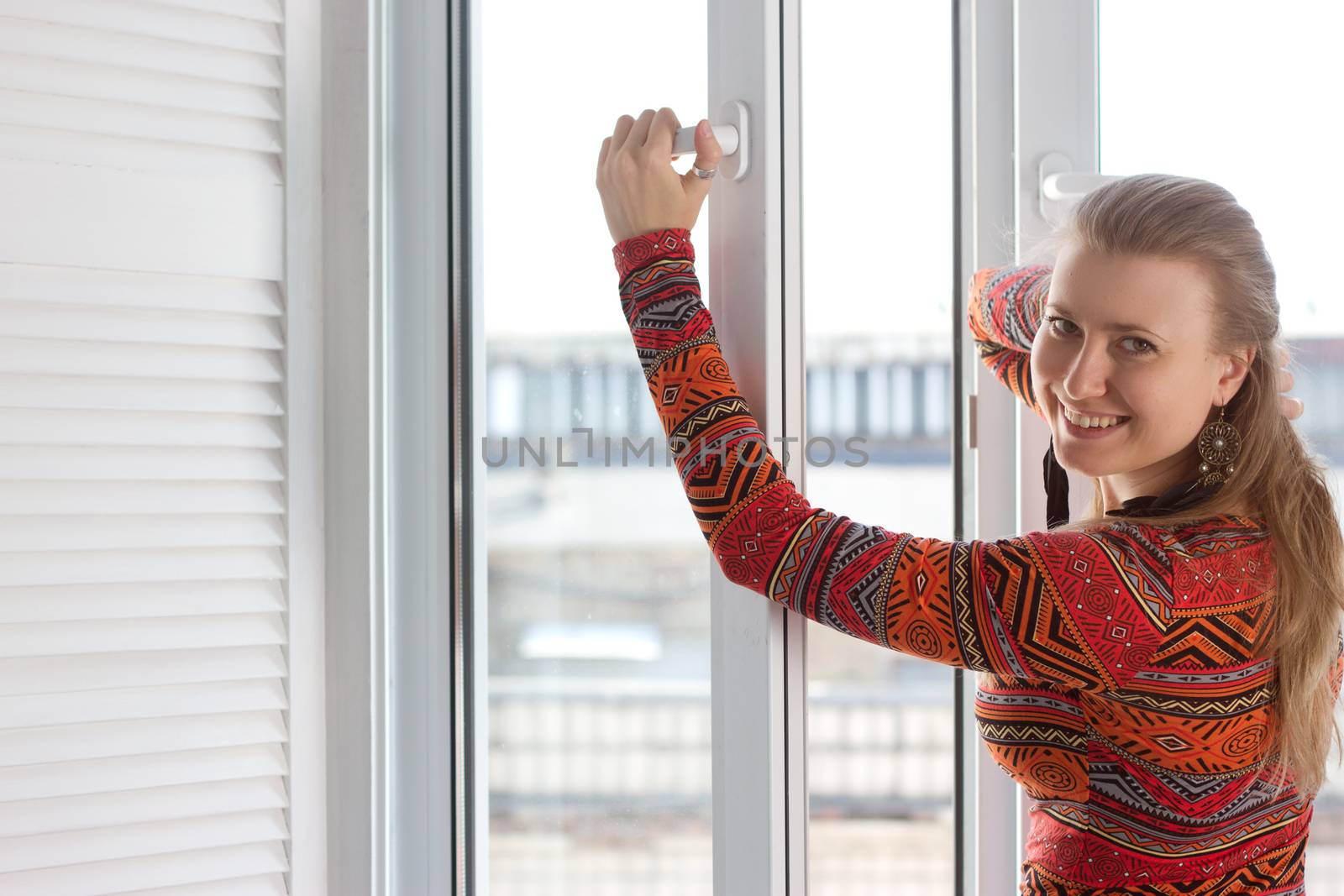 Woman opens a plastic window and smiling