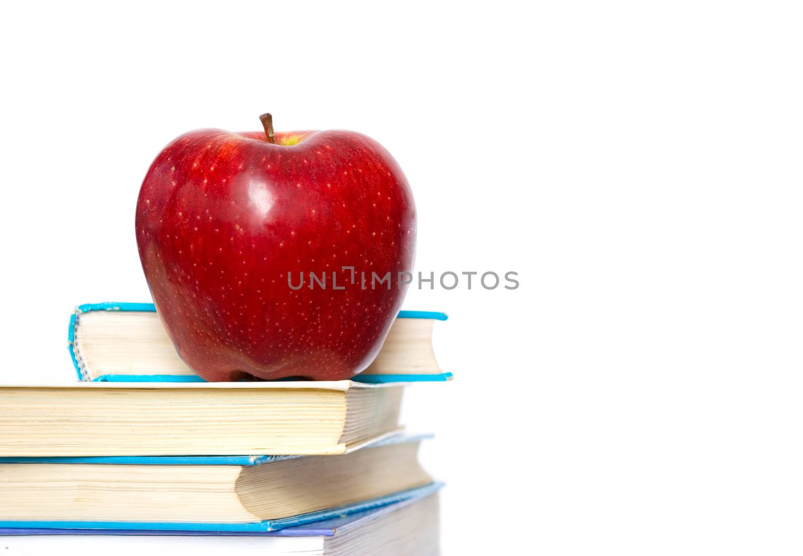 Red apple and stack of books for school