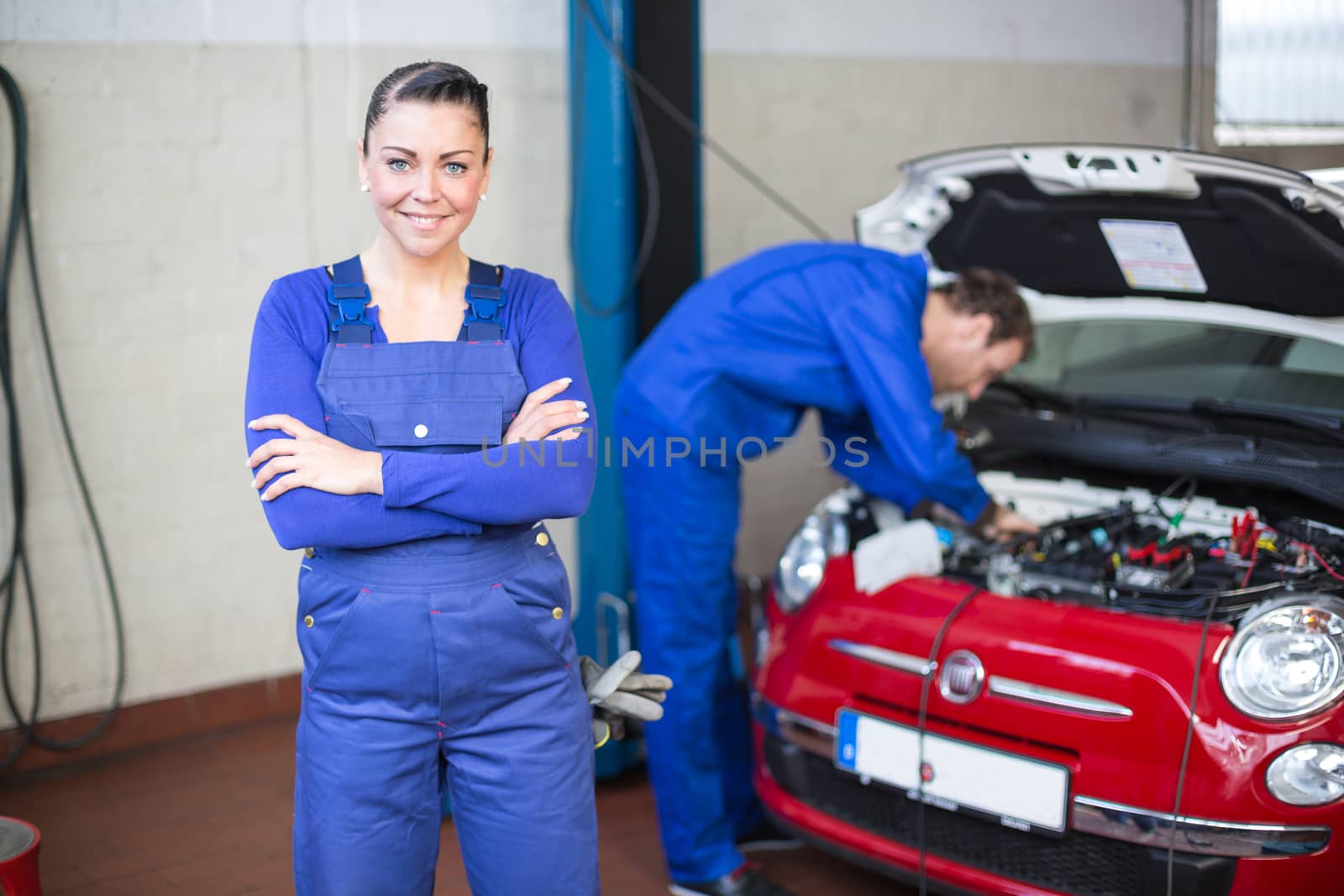 Car mechanic in garage or workshop by ikonoklast_fotografie