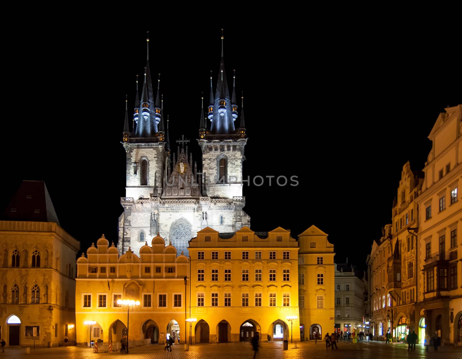 PRAGUE - February 13: Old Town Square with people, illuminated buildings and Tyn Church on background at evening. The square is very popular with tourists in Prague, Czech Republic on February 13, 2014.