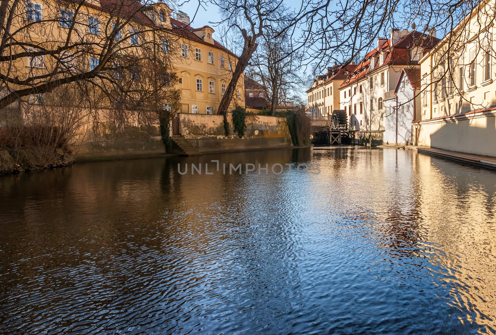 Old watermill on Chertovka river in Prague. by Zhukow