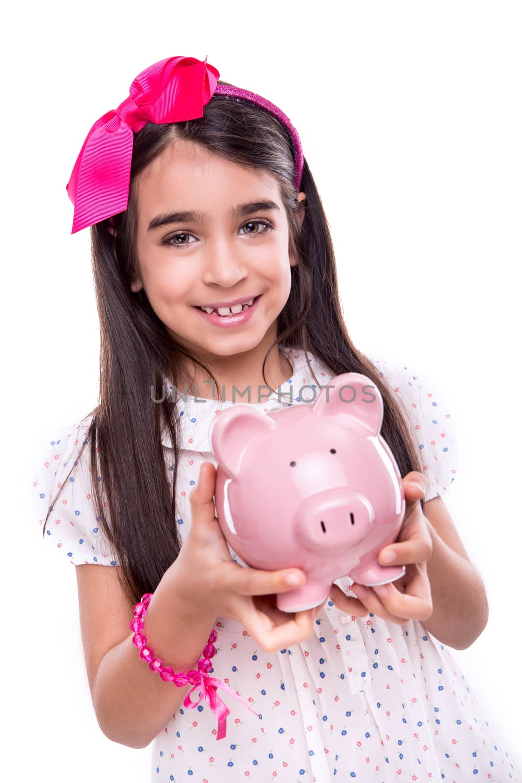 Young girl holding a piggy bank over white background