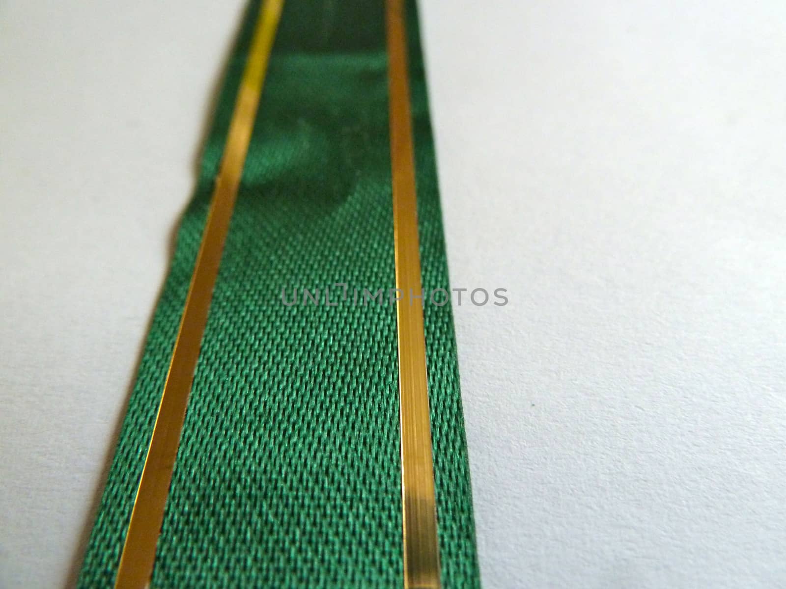 Bright green ribbon with fine gold stripes