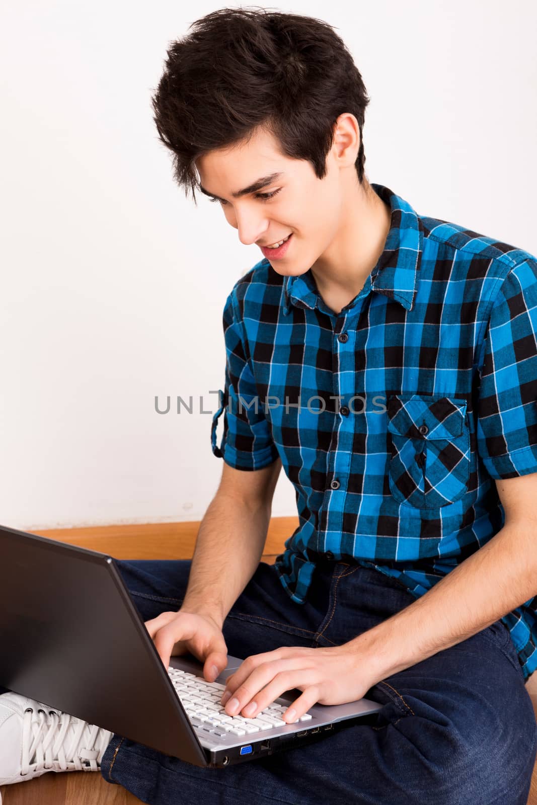 Young man working on computer laptop at home