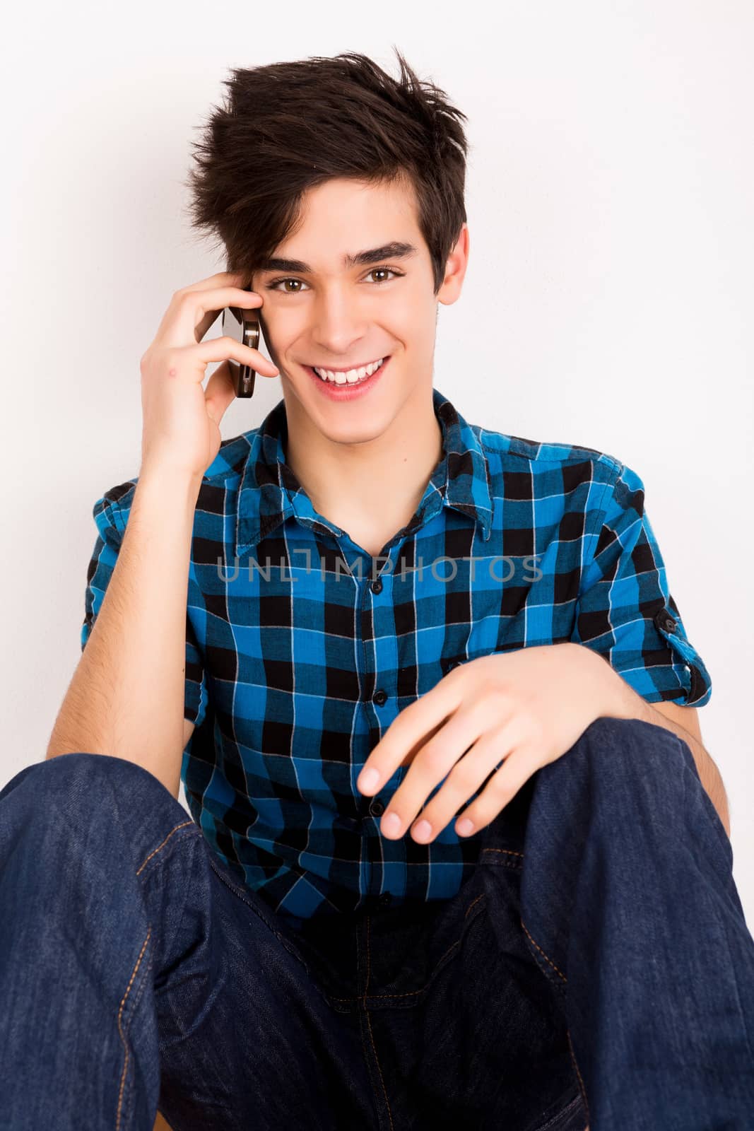 Young man talking on the phone at home