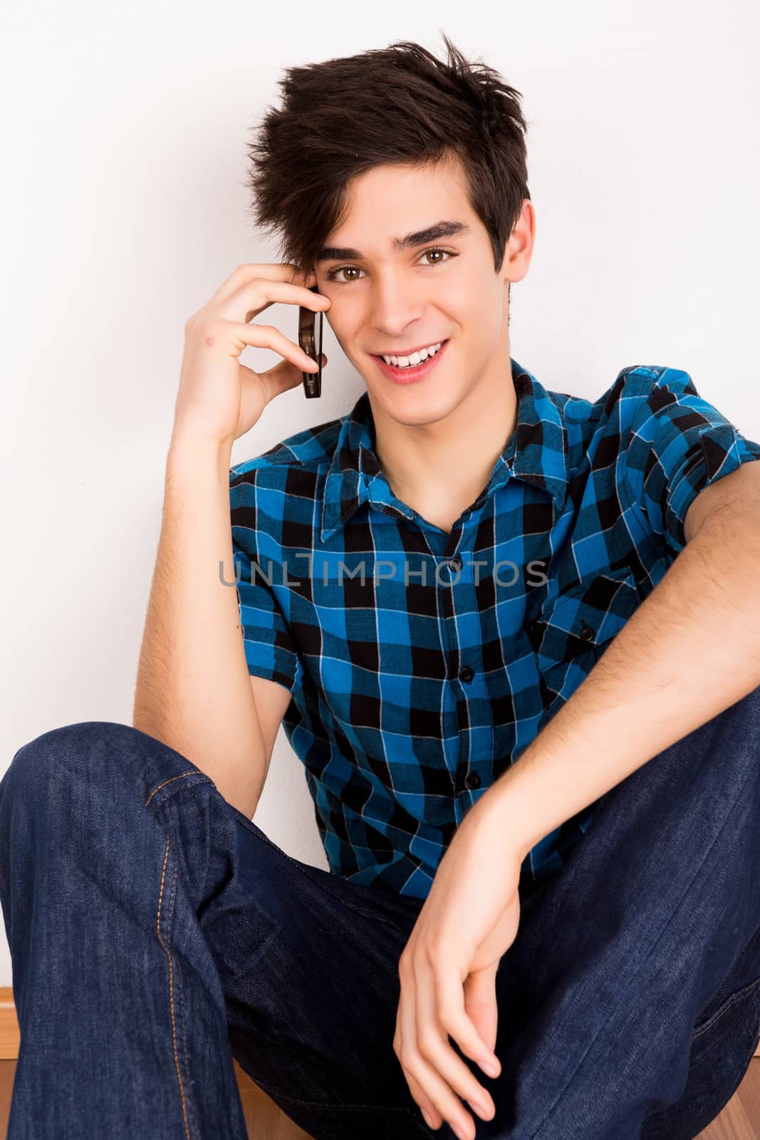 Young man talking on the phone at home