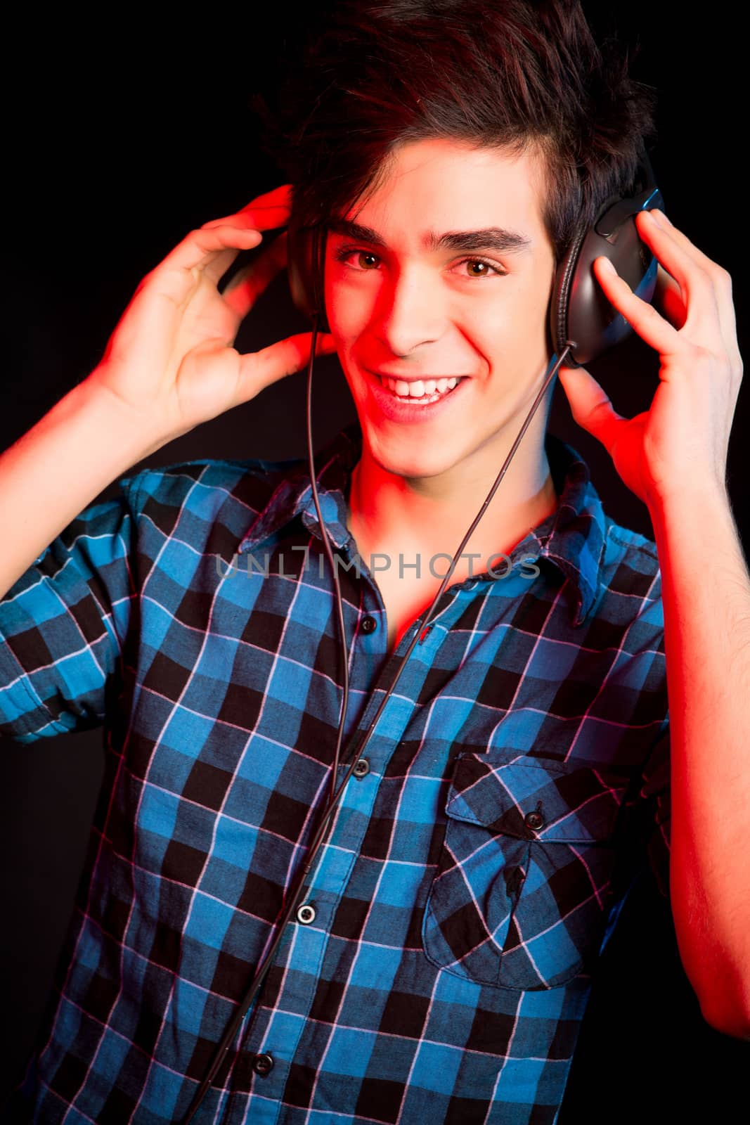 Young and handsome dj with headphones - Disco light effect