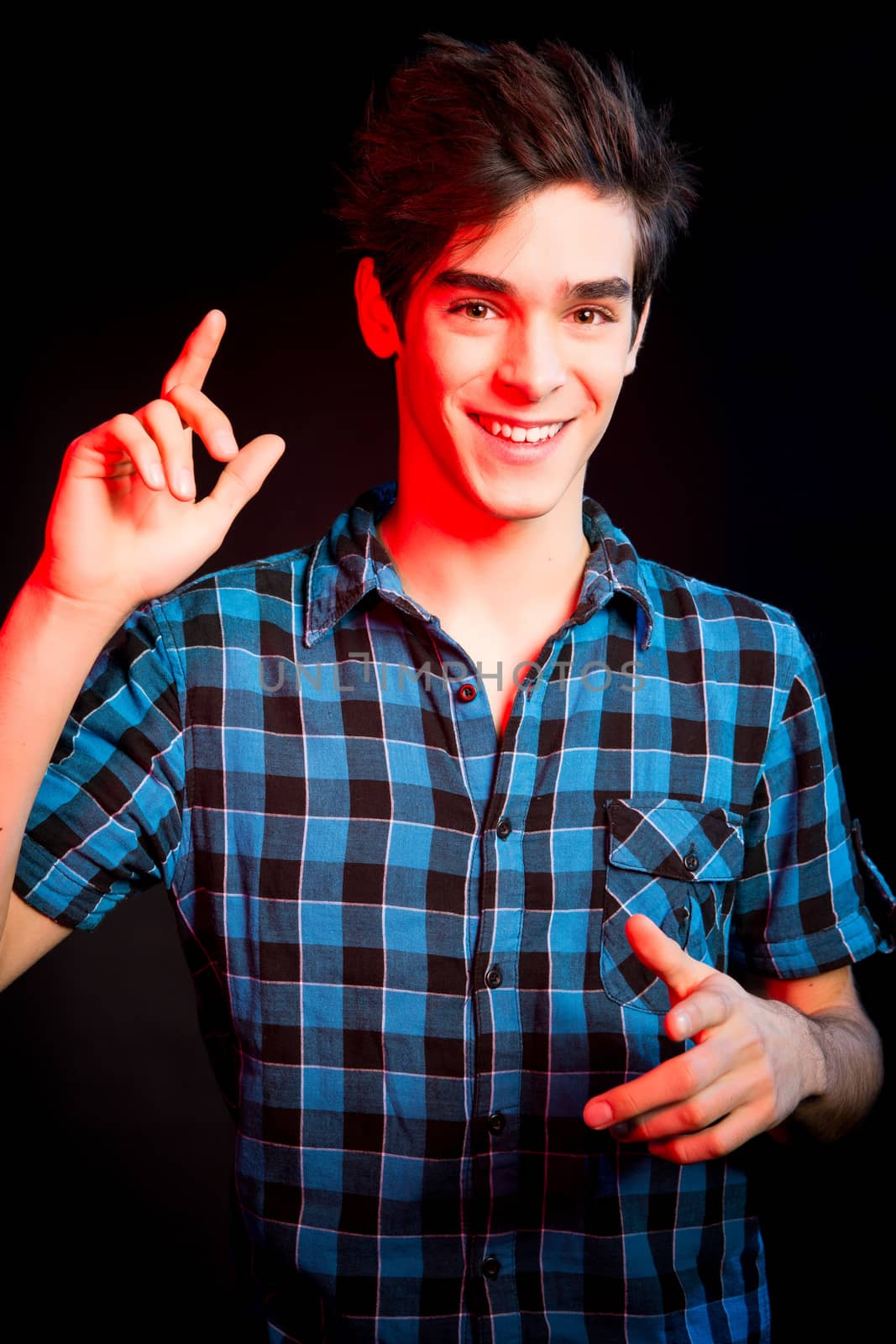 Young man dancing and enjoying music at disco