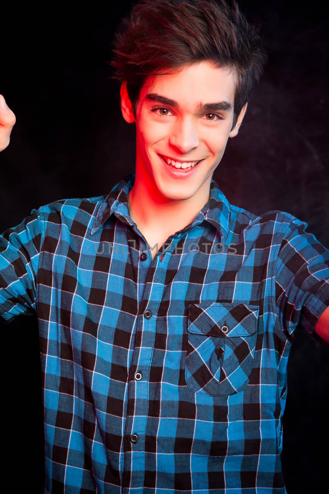 Young man dancing and enjoying music at disco by jolopes