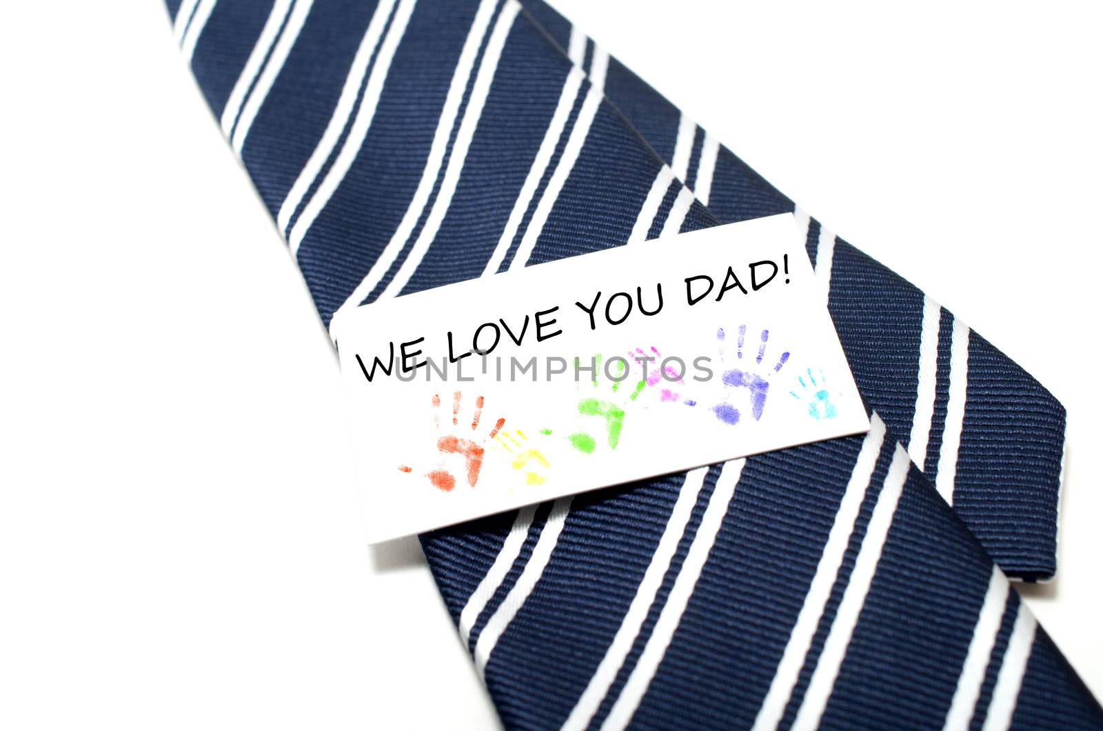 We love you dad with colorful hand prints tag on blue tie over white background