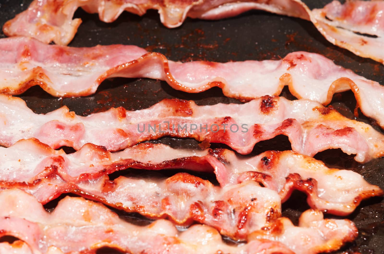 Canadian smoked bacon slices on cooking pan