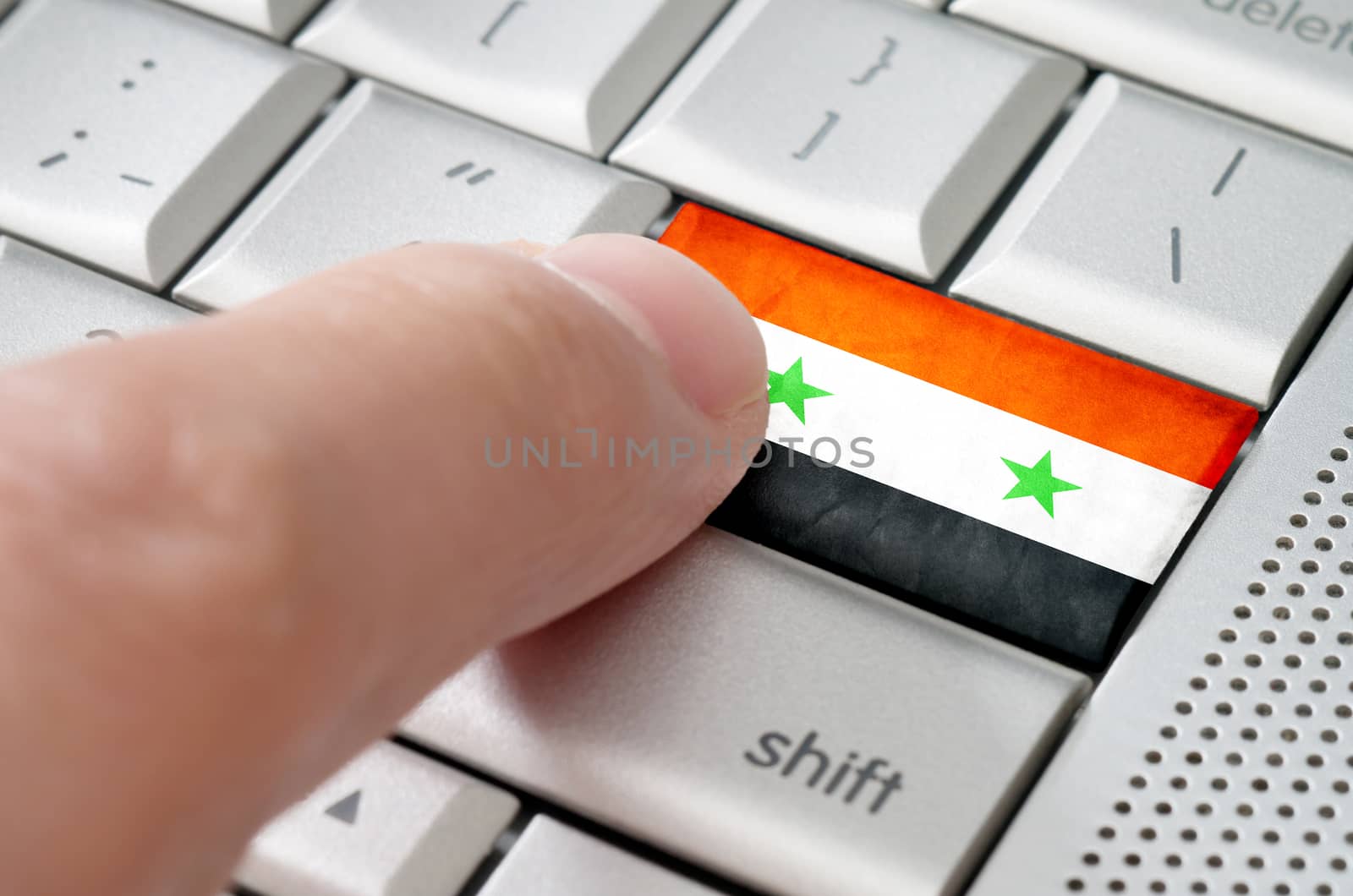 Business concept male finger pressing Syria enter key on metallic keyboard